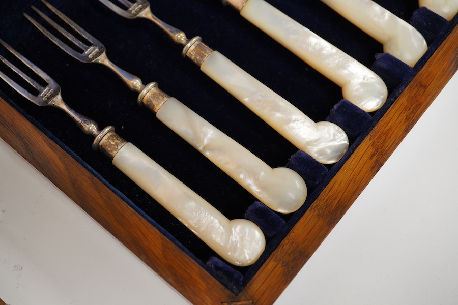 A cased set of six pairs of late Victorian mother of pearl pistol handled silver dessert eaters, by James Dixon & Sons, Sheffield, 1896, knife 20.3cm. Condition - fair to good